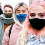 Pandemics - People Standing Behind One Another Wearing Face Masks