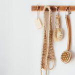 Biodegradable Plastics - Eco friendly sisal brushes back scrubber and soap hanging on wooden hook hanger in bathroom